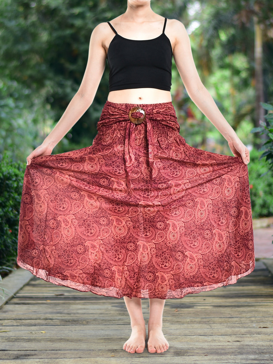 Bohotusk Red Orbit Long Skirt featuring a coconut buckle, showcasing its flowing design and elasticated smocked waist.